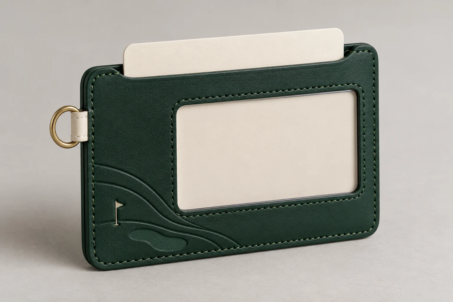 Forest-green leather membership sleeve with a clear card window, pale side loop and small brass ring