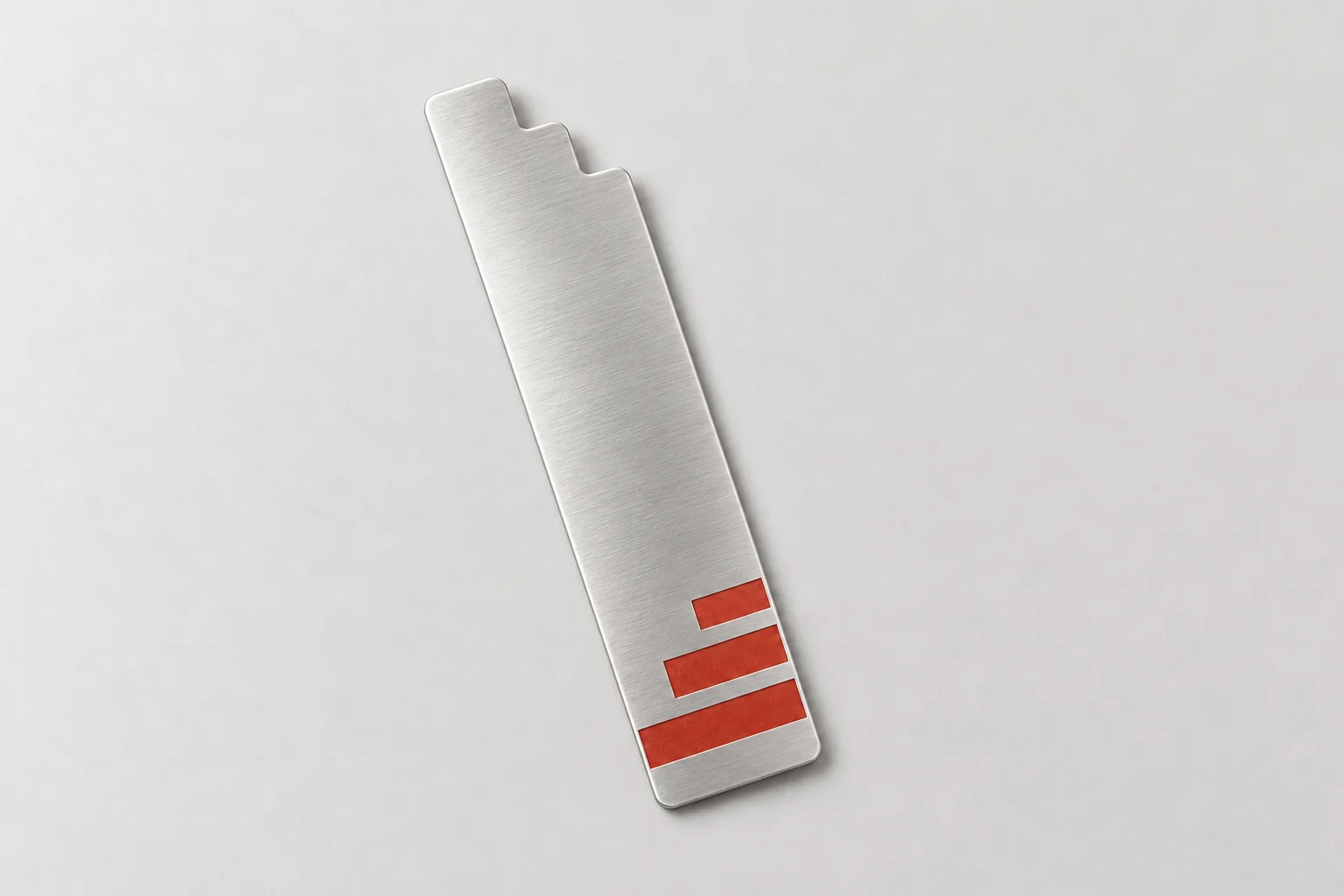 Slim silver metal bookmark with a rounded stepped top and three tomato-red horizontal bands