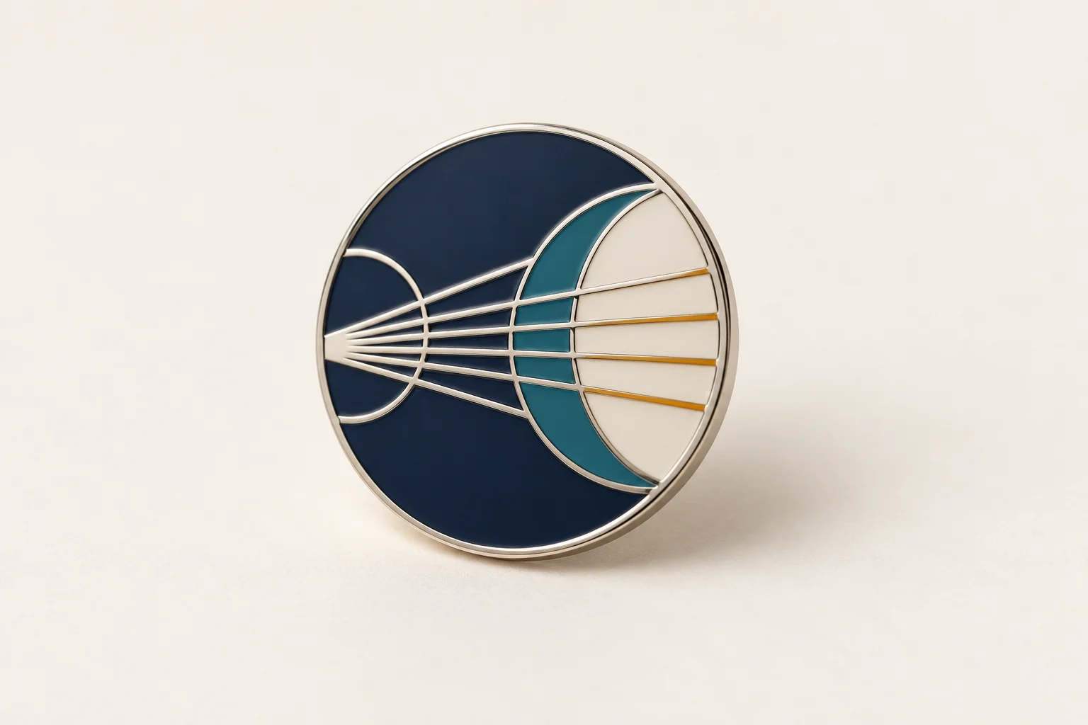 Silver-toned pin with offset lens arcs and teal color detail