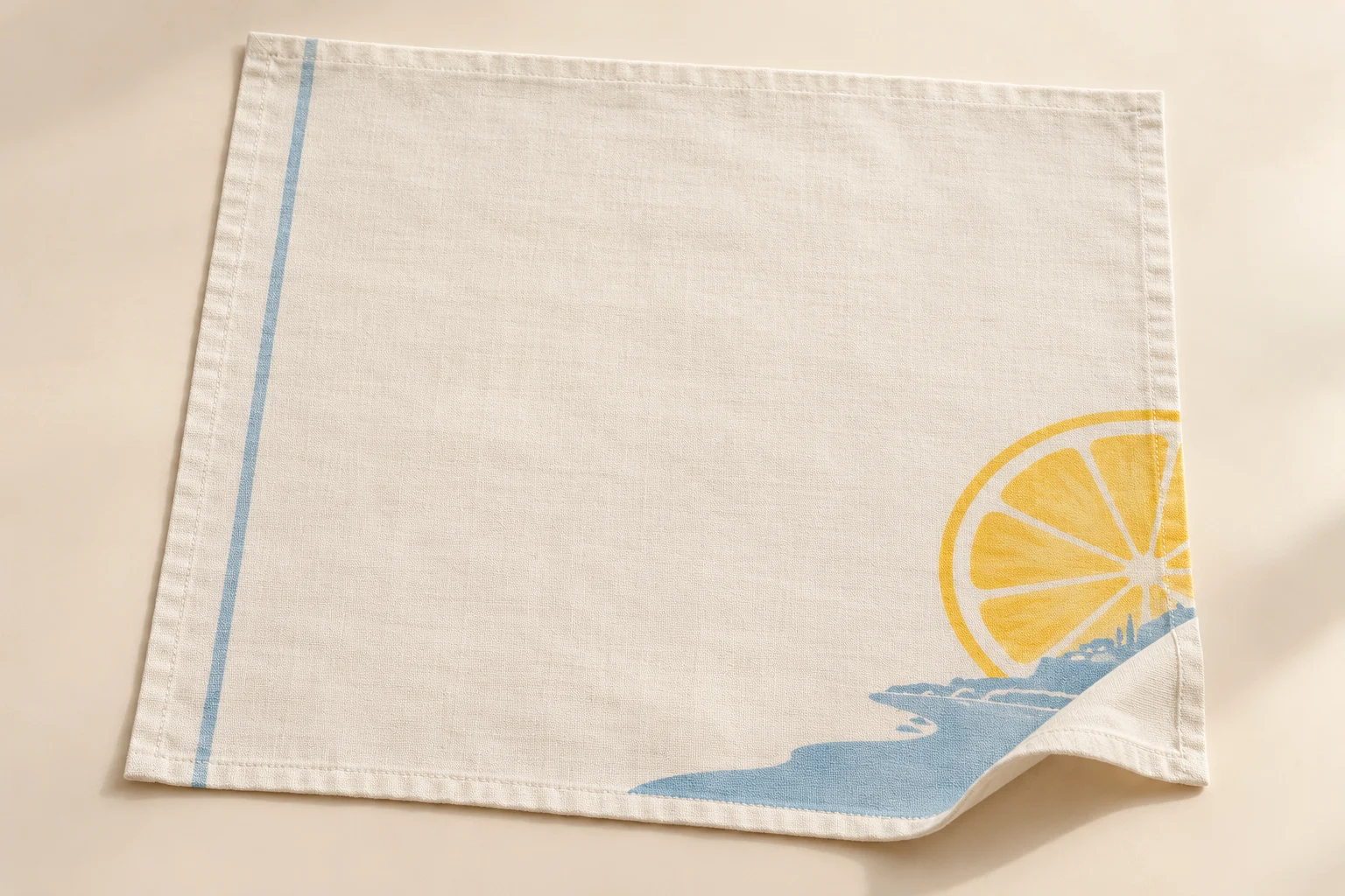 Cream cotton napkin with yellow citrus and pale-blue bay print at one corner