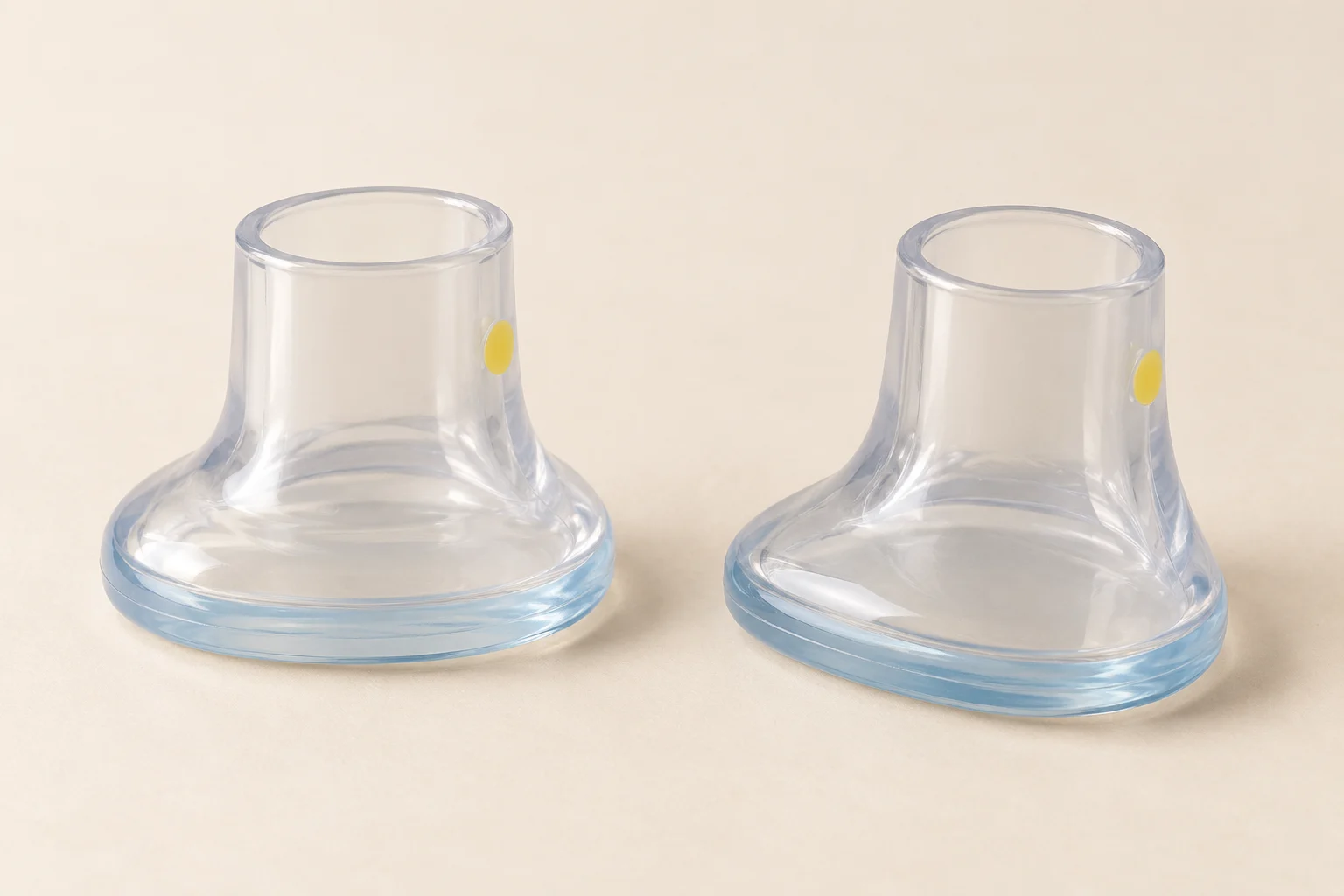 Pair of clear heel protectors with wide oval bases and pale-blue accents